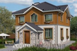 Двуxэтажный загородный дом из газобетона с фигурной крышей